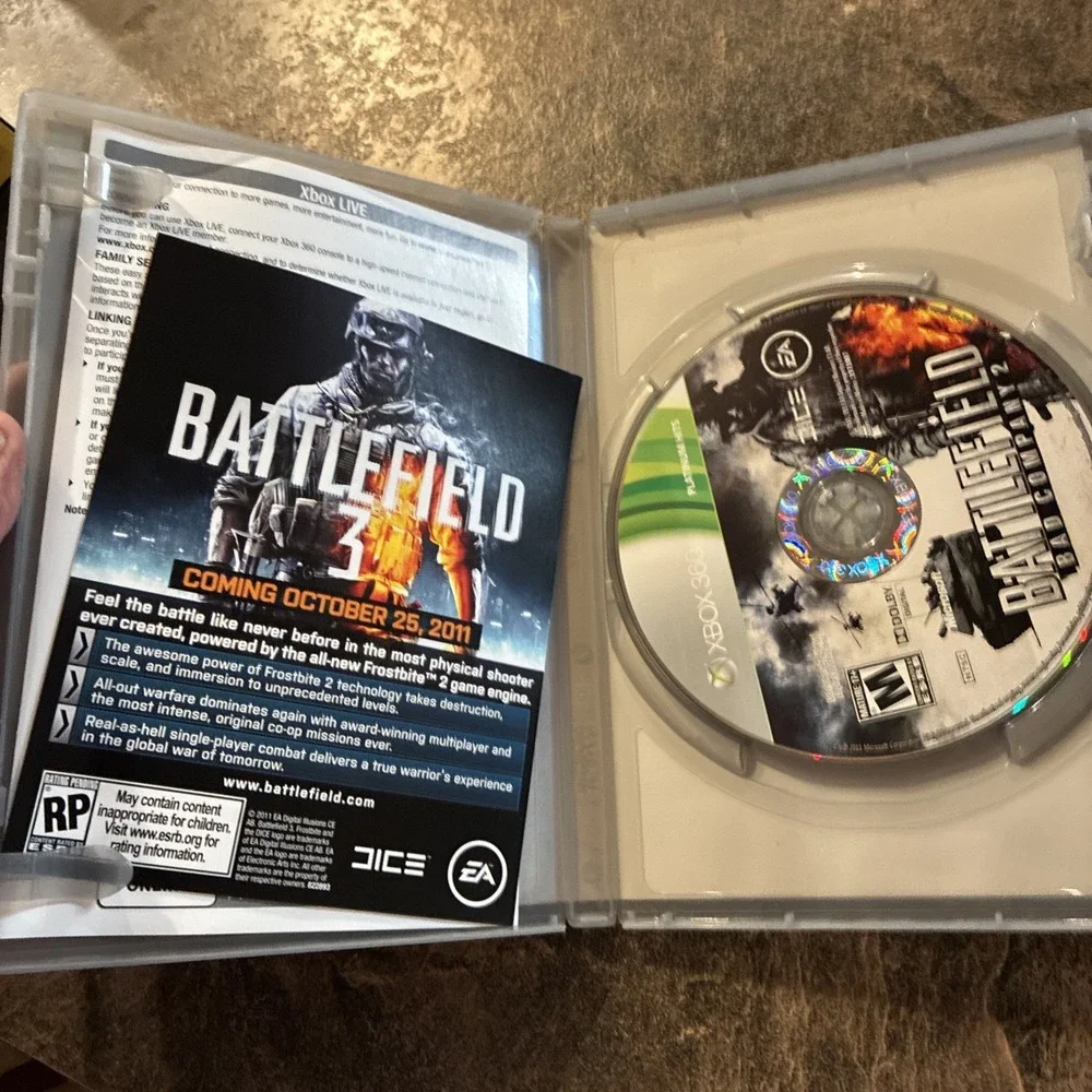 Three Xbox 360 Games, Assassin Creed, Battlefield, And Call Of Duty